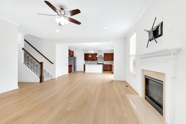 unfurnished living room featuring recessed lighting, ceiling fan, stairs, a fireplace, and light wood-type flooring