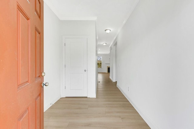 hall featuring baseboards and light wood-style floors
