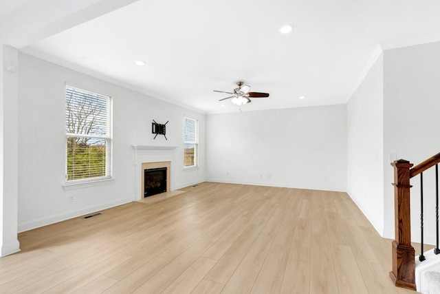 unfurnished living room featuring stairs, recessed lighting, crown molding, a ceiling fan, and light wood-style floors