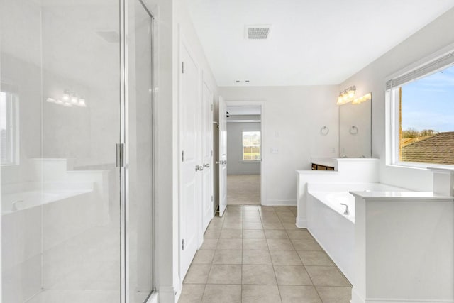 bathroom featuring a stall shower, plenty of natural light, and tile patterned floors