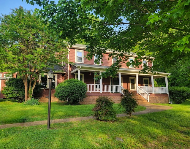 view of front facade with a front yard and a porch