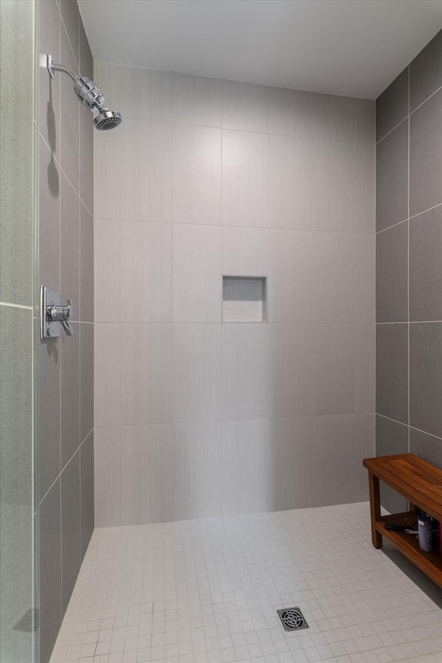 bathroom with tile walls and tiled shower