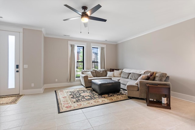 living room with ceiling fan, ornamental molding, light tile patterned flooring, and baseboards