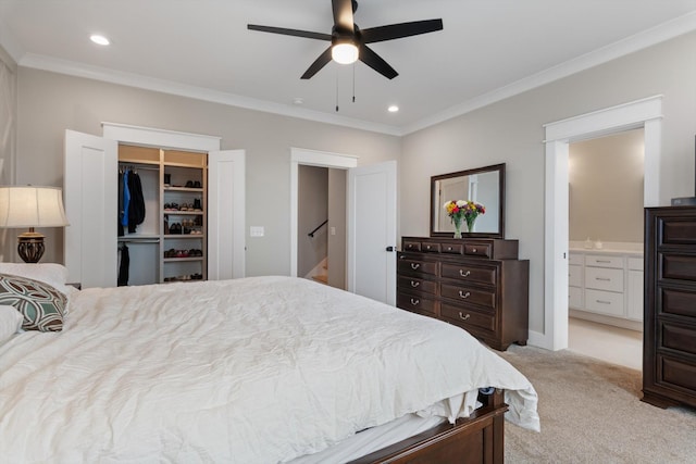bedroom featuring recessed lighting, light carpet, ensuite bath, and crown molding