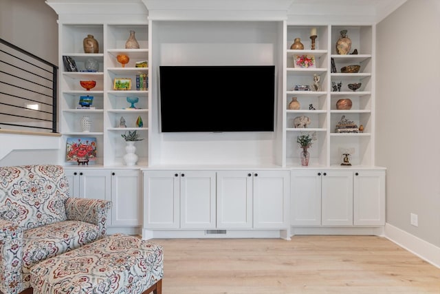 living area with light wood finished floors, stairway, baseboards, and visible vents