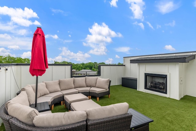 view of patio featuring an outdoor living space with a fireplace