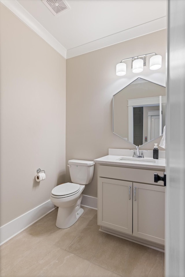 half bathroom with toilet, vanity, visible vents, tile patterned flooring, and baseboards