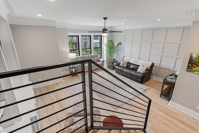 living area with light wood-type flooring, baseboards, ceiling fan, ornamental molding, and recessed lighting