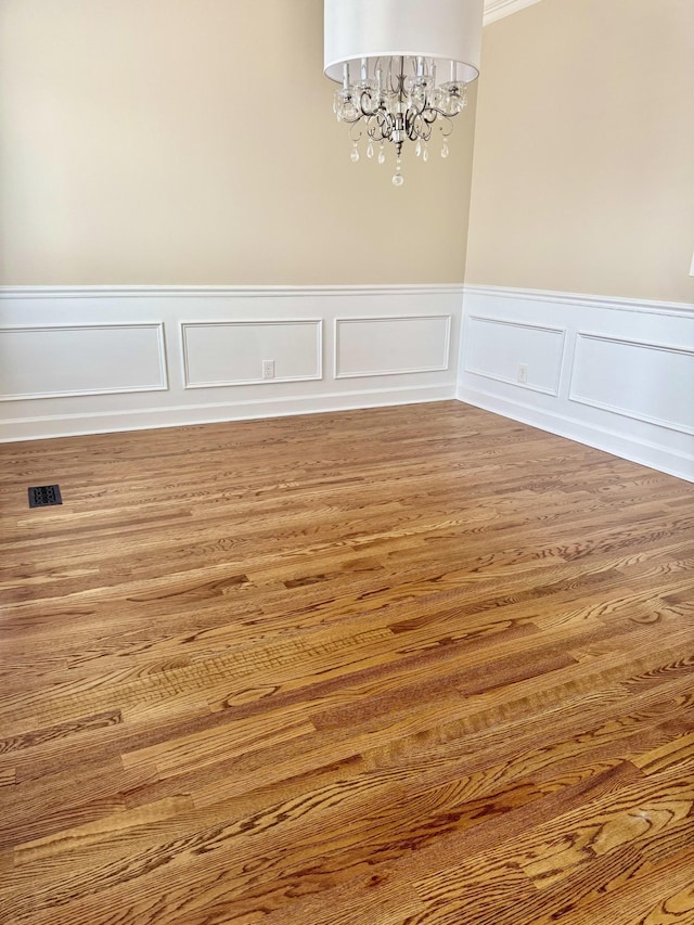 2105 Chels Way, Old Hickory, TN 37138 - unfurnished dining area with wood finished floors, visible vents, a decorative wall, wainscoting, and a chandelier