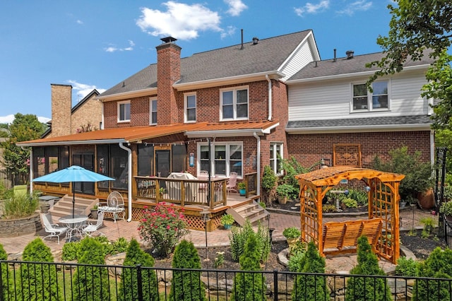 2105 Chels Way, Old Hickory, TN 37138 - back of house featuring a sunroom, a chimney, a wooden deck, brick siding, and a patio area