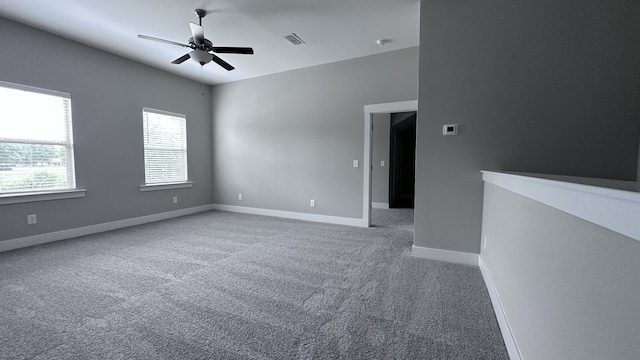 unfurnished room featuring visible vents, baseboards, a ceiling fan, and carpet floors