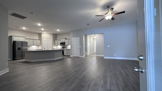 kitchen with ceiling fan, stainless steel appliances, visible vents, and open floor plan