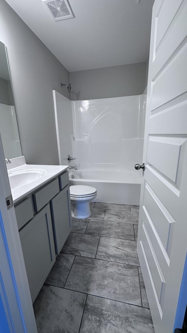 full bath with vanity, toilet, tub / shower combination, and visible vents