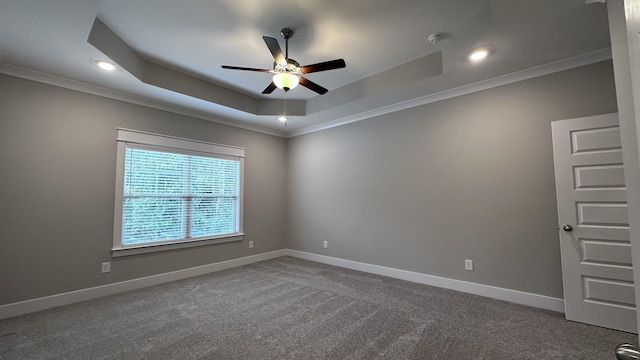 carpeted spare room featuring recessed lighting, baseboards, ceiling fan, crown molding, and a raised ceiling