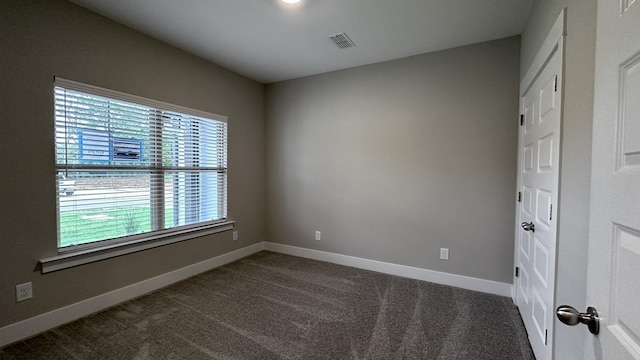 carpeted empty room with visible vents and baseboards