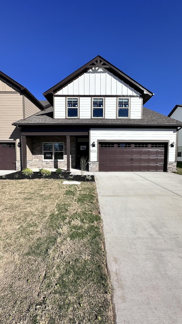 view of front of house featuring concrete driveway, board and batten siding, stone siding, and a garage