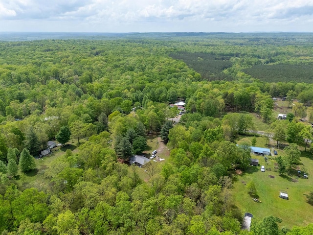 birds eye view of property featuring a view of trees