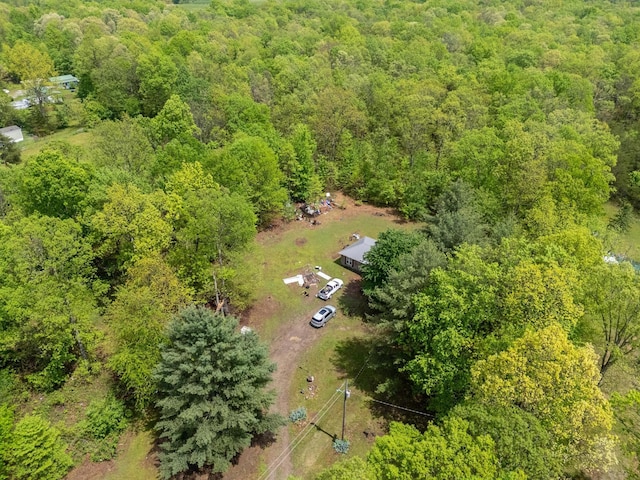 drone / aerial view featuring a wooded view