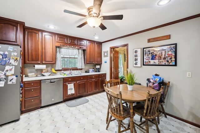 kitchen with light floors, stainless steel appliances, ceiling fan, a sink, and light countertops