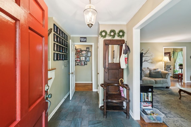 entrance foyer featuring ornamental molding, baseboards, and stone finish floor
