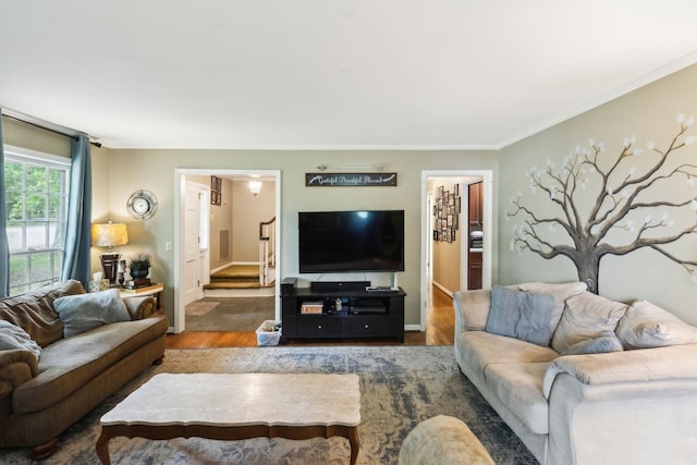 living room with crown molding and wood finished floors