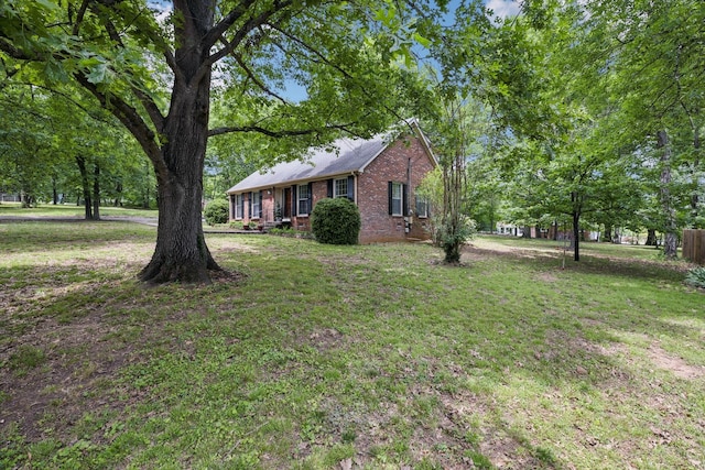 view of front facade featuring a front lawn and brick siding