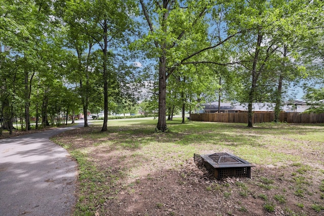 view of yard with a fire pit and fence