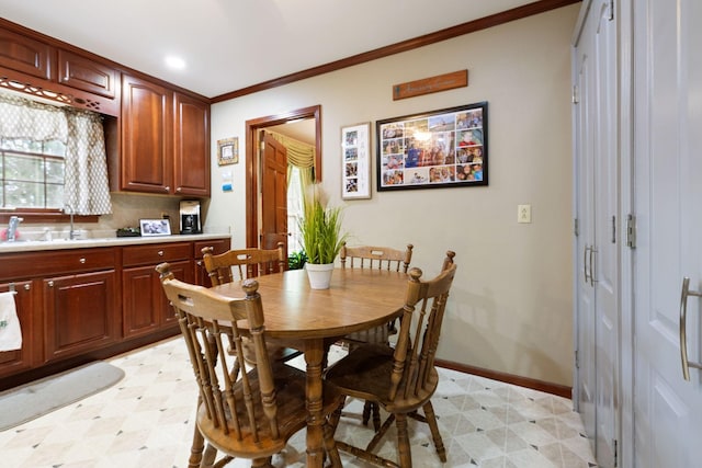 dining room with ornamental molding, light floors, baseboards, and recessed lighting