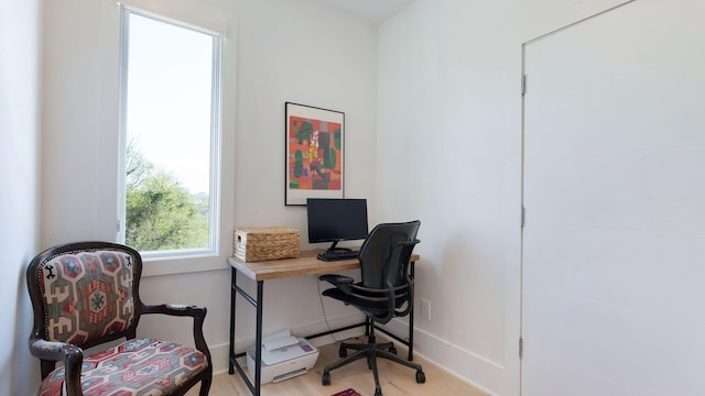 office area featuring light wood-style floors and baseboards
