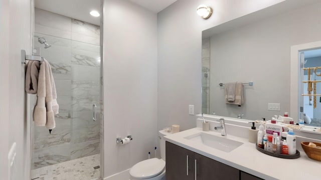 full bathroom with a stall shower, vanity, and toilet