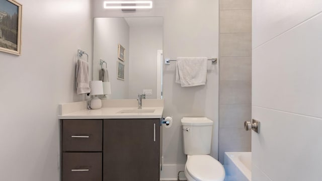 full bath with toilet, vanity, and a bath