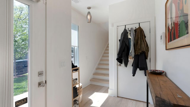 foyer entrance featuring stairs and wood finished floors