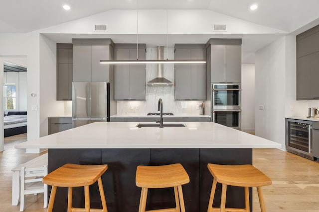 5734 Willoughby Way, Murfreesboro, TN 37129 - kitchen featuring stainless steel appliances, gray cabinetry, beverage cooler, and vaulted ceiling