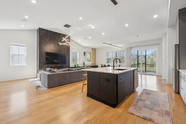 5734 Willoughby Way, Murfreesboro, TN 37129 - kitchen with hanging light fixtures, a sink, open floor plan, light countertops, and lofted ceiling