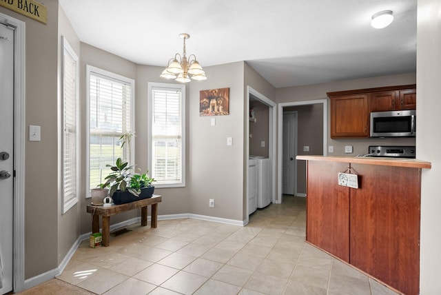 3144 Holly Pt, Clarksville, TN 37043 - kitchen with stove, a chandelier, stainless steel microwave, and a wealth of natural light