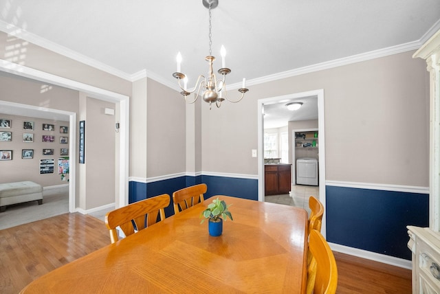 3144 Holly Pt, Clarksville, TN 37043 - dining room with washer / dryer, an inviting chandelier, baseboards, and crown molding