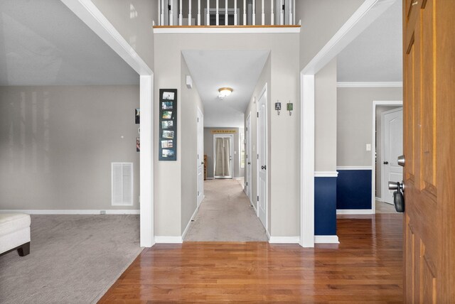 3144 Holly Pt, Clarksville, TN 37043 - foyer with carpet, visible vents, wood finished floors, and baseboards