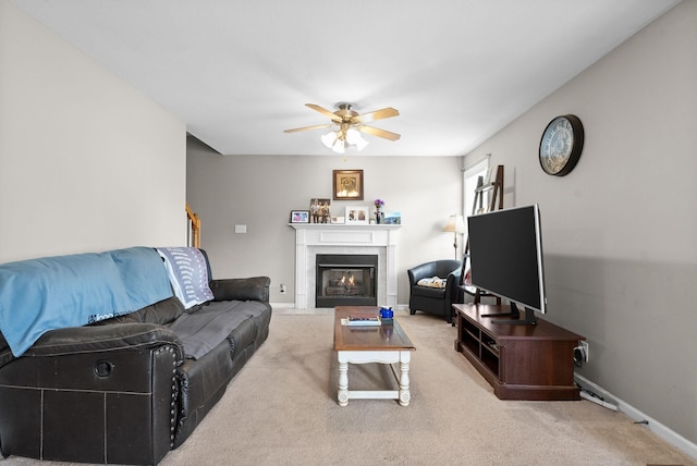 3144 Holly Pt, Clarksville, TN 37043 - living room featuring ceiling fan, carpet flooring, baseboards, and a glass covered fireplace