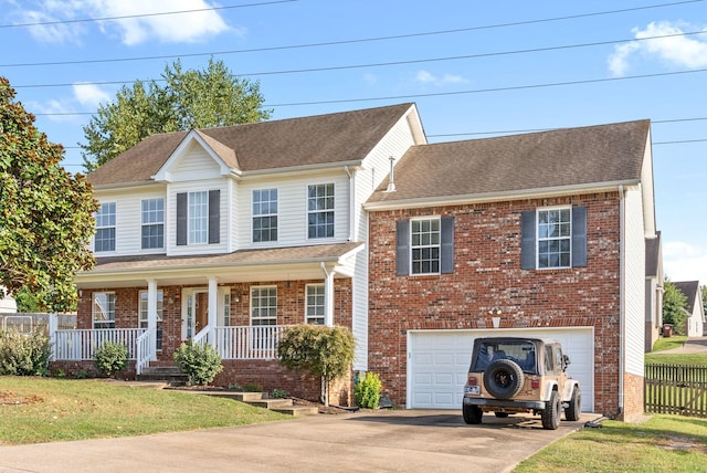 3144 Holly Pt, Clarksville, TN 37043 - colonial home with a porch, an attached garage, brick siding, driveway, and a front yard