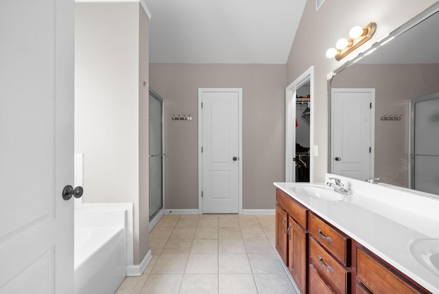 3144 Holly Pt, Clarksville, TN 37043 - bathroom featuring double vanity, a garden tub, a stall shower, a sink, and baseboards