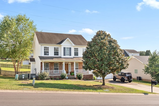 3144 Holly Pt, Clarksville, TN 37043 - view of front of property featuring brick siding, fence, covered porch, concrete driveway, and a front yard