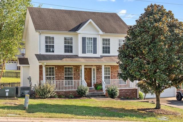 3144 Holly Pt, Clarksville, TN 37043 - view of front of property with covered porch, roof with shingles, a front lawn, and central air condition unit