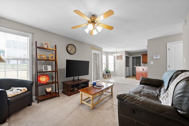 3144 Holly Pt, Clarksville, TN 37043 - living room featuring light carpet, baseboards, and ceiling fan with notable chandelier