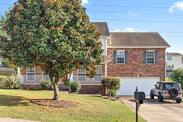 3144 Holly Pt, Clarksville, TN 37043 - view of front facade with an attached garage, brick siding, driveway, and a front lawn