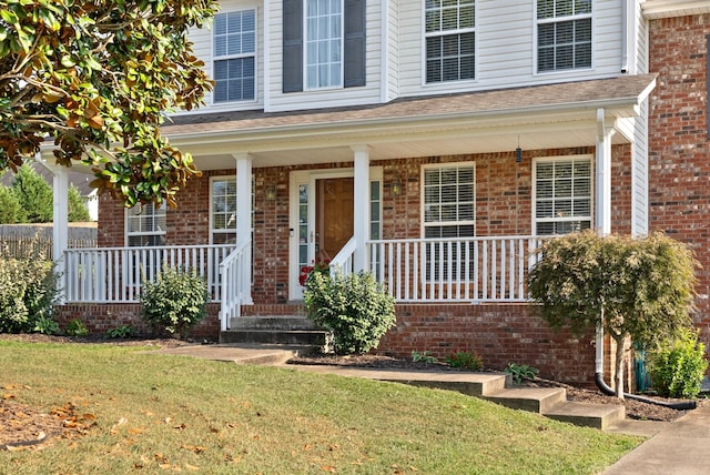 3144 Holly Pt, Clarksville, TN 37043 - doorway to property with a lawn, brick siding, and covered porch