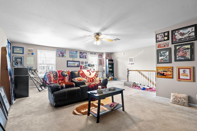 3144 Holly Pt, Clarksville, TN 37043 - living room featuring a ceiling fan, baseboards, visible vents, and light colored carpet