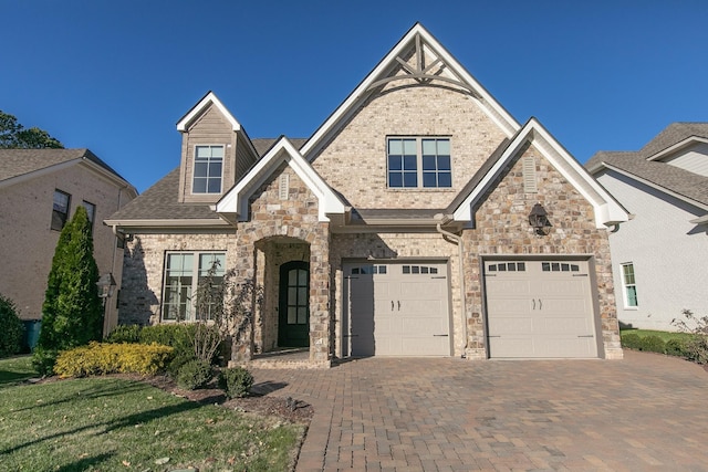 2115 White Poplar Ct, Murfreesboro, TN 37130 - view of front of home featuring decorative driveway, an attached garage, stone siding, and roof with shingles