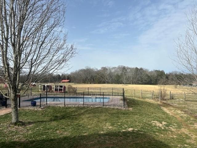 community pool with a yard and fence