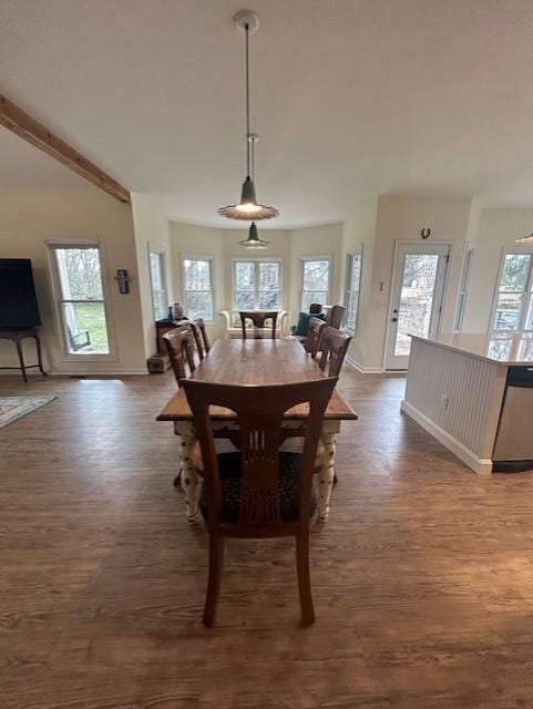 dining area with baseboards and dark wood-type flooring