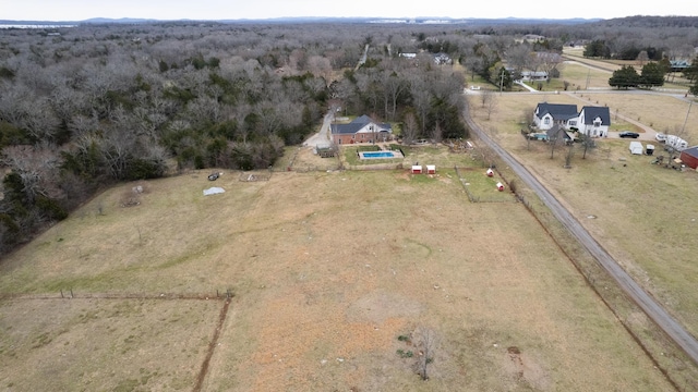 aerial view featuring a rural view and a view of trees